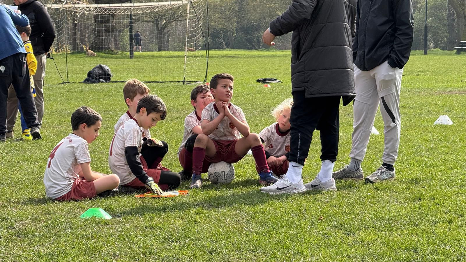 Coach encouraging a young player during training