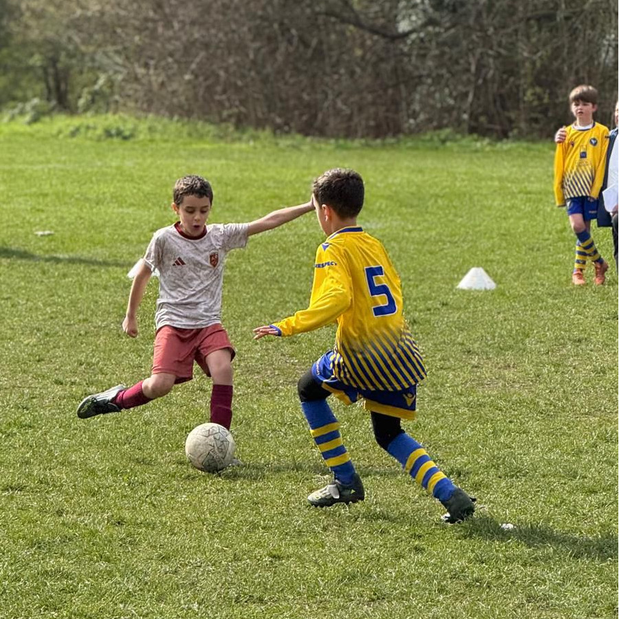 Children celebrating after a football drill