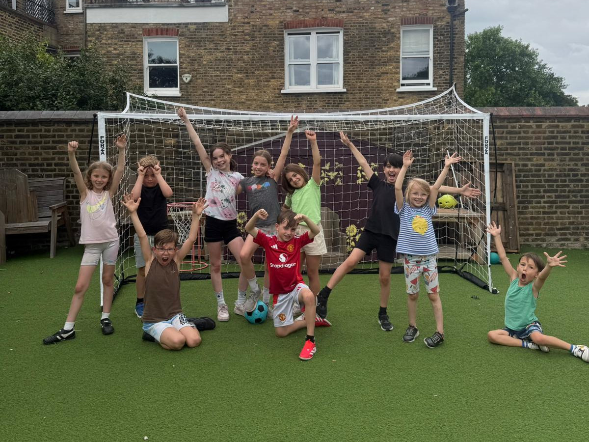 Children taking part in a football camp and school club session
