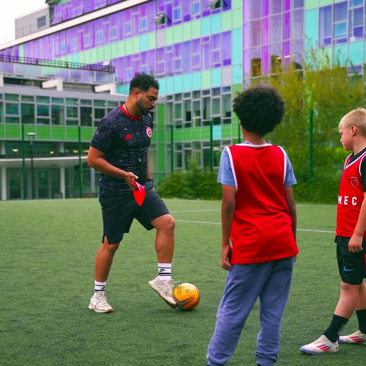 Coach demonstrating a movement pattern to players