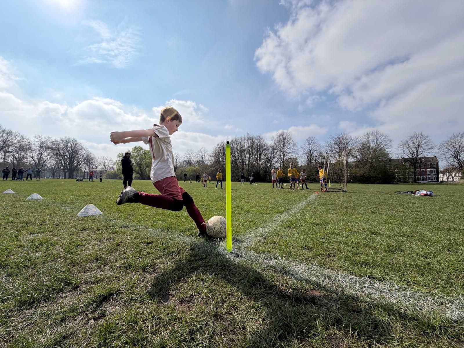 Young footballers training together on a bright pitch